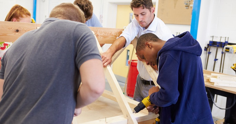 TeacherHelpingStudentsfeat | Schools Week